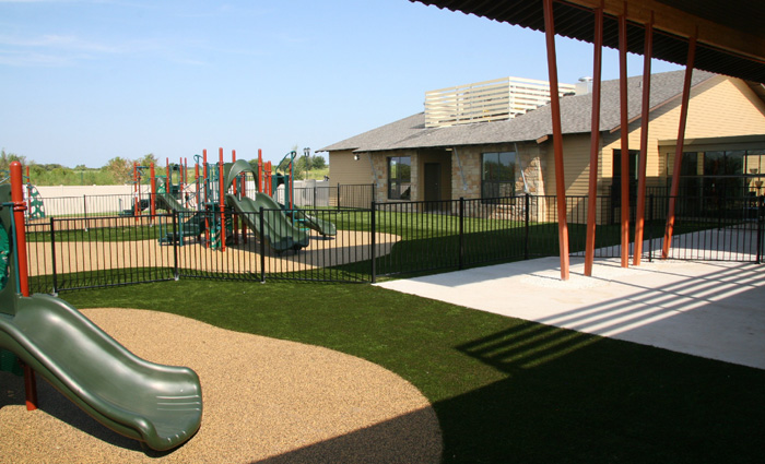 Playground with rubberized fall surface and artificial turf